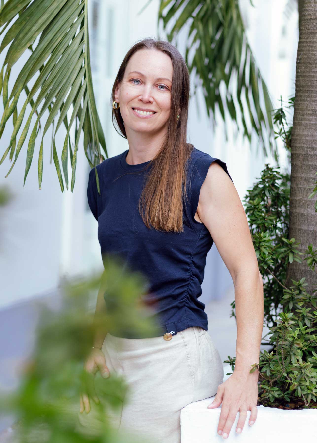 Lynn Hawthorn standing near a palm tree | Physis Publishing | Quietly Iconic Brands